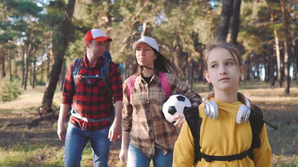 Happy Family Hiking Through a Forest