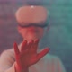 Close up of young woman wearing vr goggles and holding her hand up towards the camera - VideoHive Item for Sale