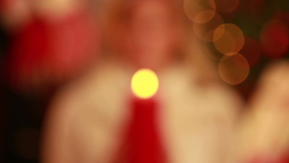 Pretty blonde holding candle at christmas