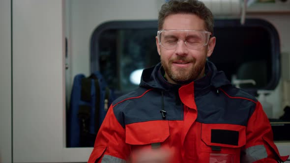 Smiling Paramedic Sitting in Emergency Car