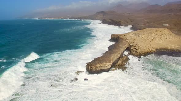 Aerial view of waves crashing on the shore at Punta Guadalupe.