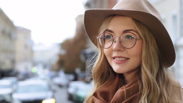 Young Beautiful Caucasian Girl Standing Outdoors Closeup Millennial Woman with Hat and Glasses on