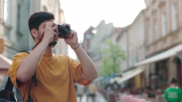 Indian Guy Taking Photos of Old City Using Retro Camera