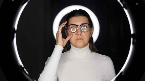 Woman in Glasses Over White Illumination on Black