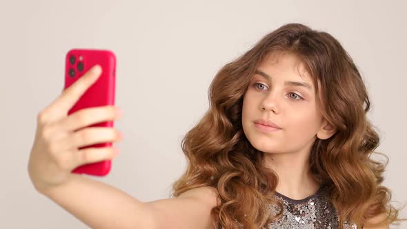 Portrait of a Smiling Girl Taking a Selfie Photo