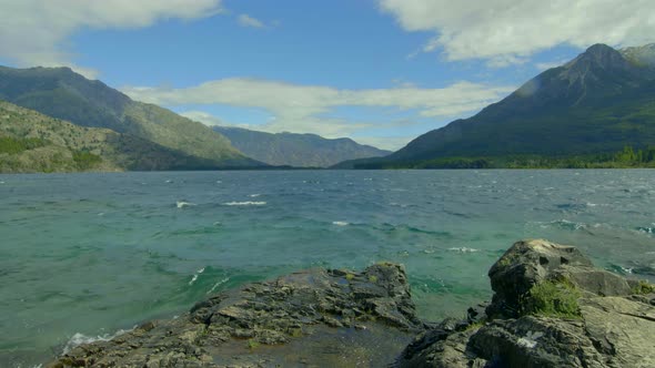 Turquoise rough waters on a  windy day. Lake Emerald Epuyen Patagonia Argentina. Slider slow move. p