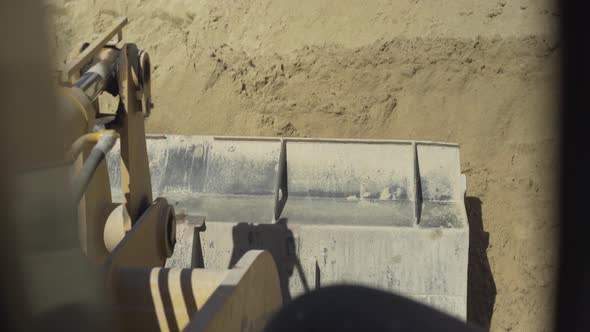 Driver's POV of Sand Picking on Outdoor Manufacturing Site. Bucket of Loader Tractor Riding To Pile