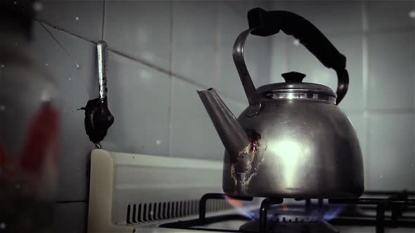 Old Tea Kettle on an Oven in the Kitchen.