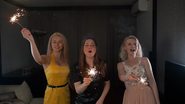 Three Ladies Happy Dancing with Sparklers.