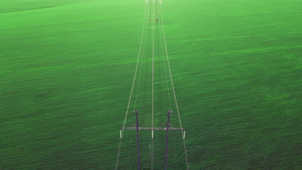 High voltage power line on industrial electricity line tower.