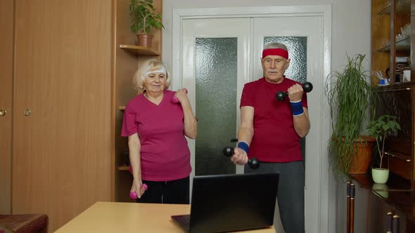 Senior Elderly Couple Grandmother Grandfather Doing Workout with Dumbbells Fitness Exercising