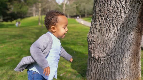 Little Boy Running Around Tree, Playing Hide-and-seek, Smiling