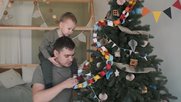 Child Boy with His Dad Decorating Christmas Tree