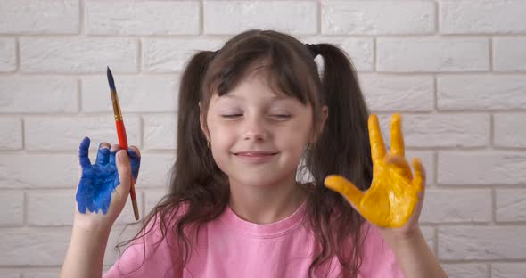 Child Draw with Colorful Hands at Home