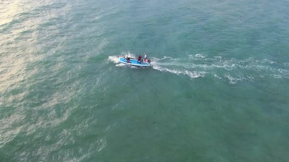 Aerial view of traditional fishing boat driving in the sea of Rio do Fogo.