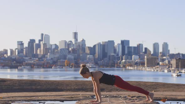 Woman Doing Yoga Bhujangasana Or Cobra Pose In City Location