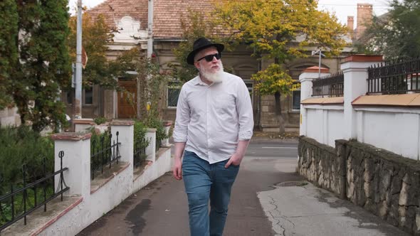 Caucasian Young Man with Albinism Is Walking Outside