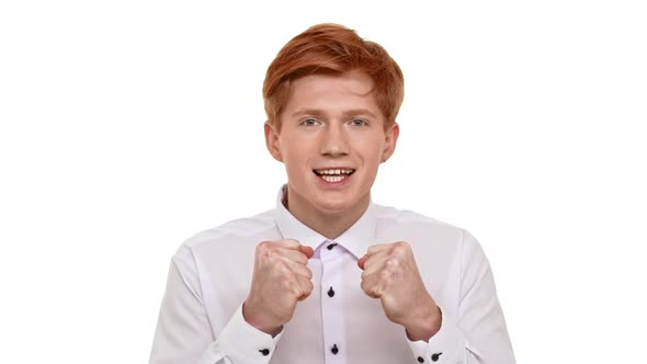 Young Ginger Caucasian Boy Standing on White Background in Excitement Awaiting for His Sport Team