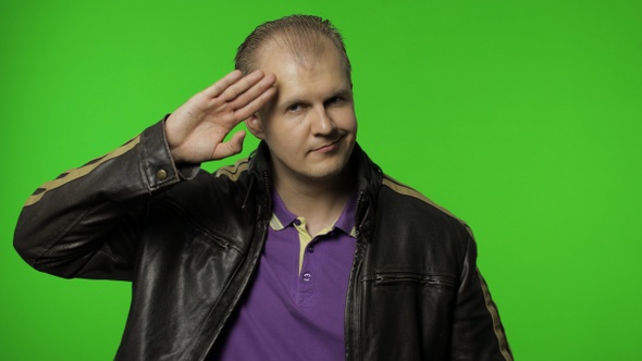 Rocker Man Saluting with Hand and Pretending To Listen Order, Guy Biker on Chroma Key Background