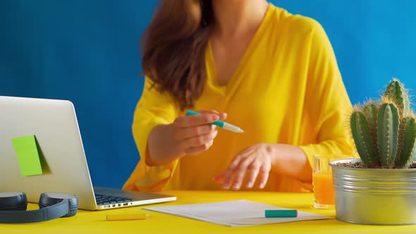 Woman in a Yellow Blouse Works Remotely at Home During a Pandemic