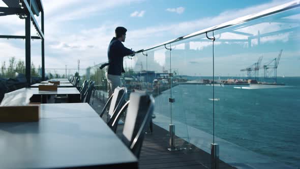 Man Resting Rooftop Terrace Enjoying Sea View