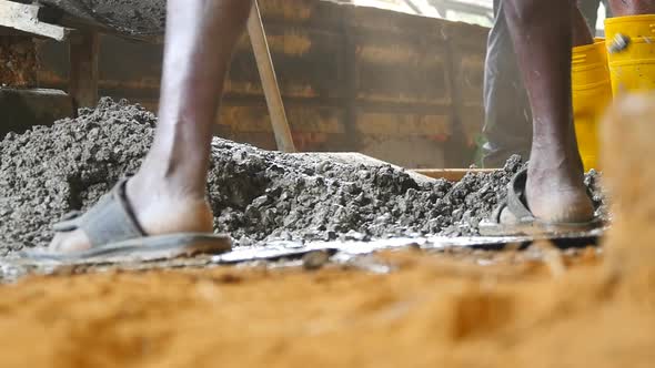 Local Indian Builders Gathers Wet Cement with Shovels To the Pile at Building Site. Adult