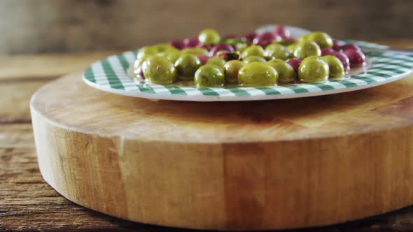 Plate of pickled olives and herbs