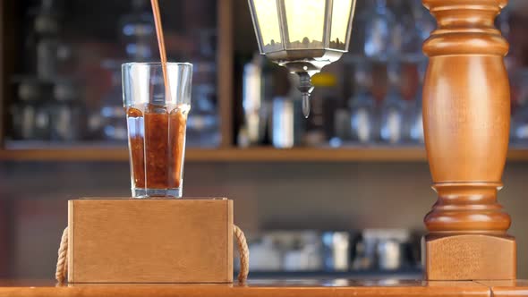 Pour Beer Into a Transparent Glass on the Bar