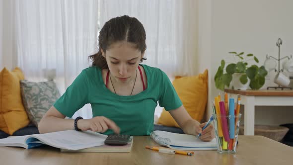 Frustrated teen girl trying and failing to prepare homework for school