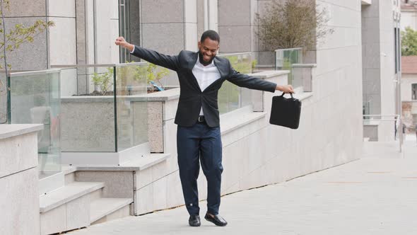 Happy Young African American Millennial Businessman Dancing Alone Outside Celebrating Friday