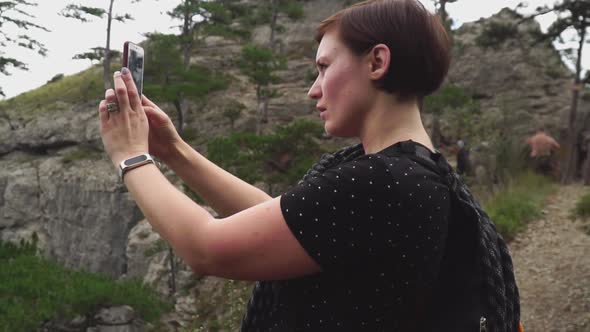 Woman Traveling, Making Photo of Beautiful Green Forest and Mountains Nature Landscape on Smart