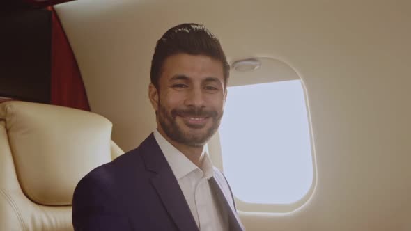Smiling businessman sitting in the jet.
