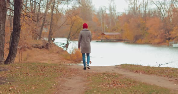 Woman with a Dog Goes Down to the Riverbank