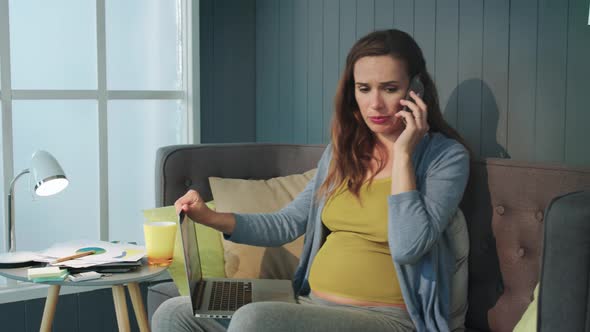 Closeup Sad Pregnant Businesswoman Talking Phone at Home Office.