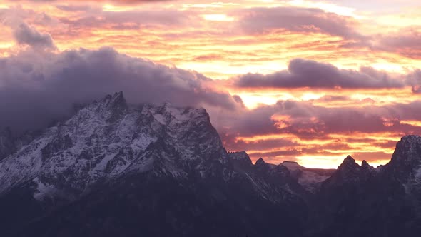 Panning the Grand Teton mountains during colorful sunset