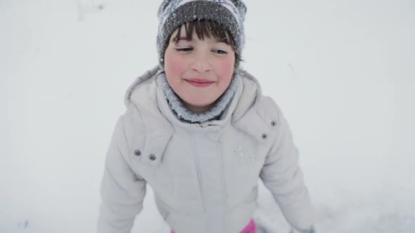 Happy Cute Little Girl Making Snow Angel