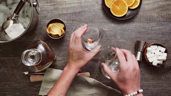 Step by step. Preparing Bourbon old fashioned cocktail at home bar.