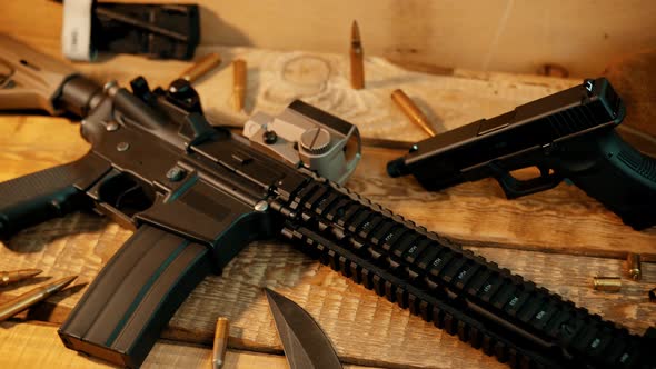 Assault Rifle and Military Equipment on a Wooden Table