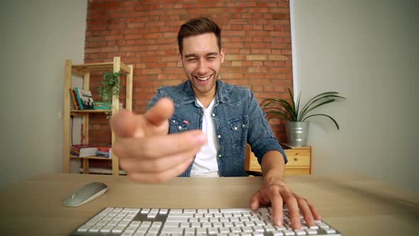 POV of Cheerful Handsome Young Man Laughing During Online Live Video Conference Call By Desktop