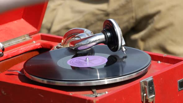 An Old Portable Gramophone Plays Vinyl Record