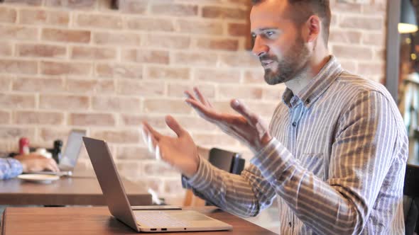 Online Video Chat on Laptop By Man at Work