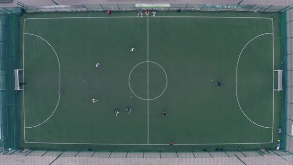 Players Play Football on a Green Football Field with White Markings  Drone Static Shot