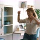 Excited and joyful middle age woman dancing at home singing a song for happiness - VideoHive Item for Sale