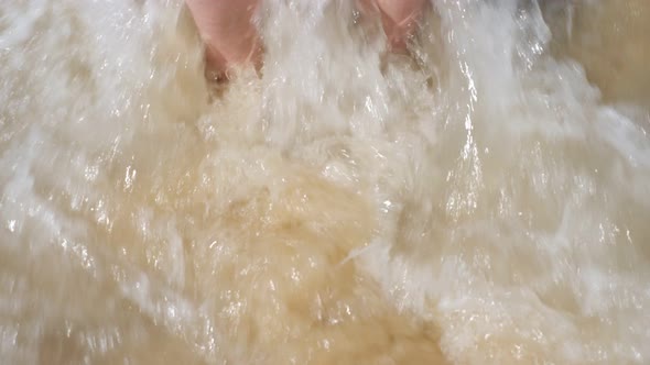 Waves Roll on Sand Beach Washing Girl Feet with Red Pedicure