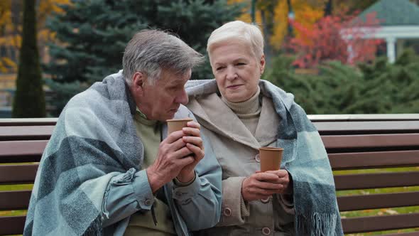 Loving Middleaged Couple Pensioners Man Woman Grandparents Rest Together Sit on Bench Outdoors