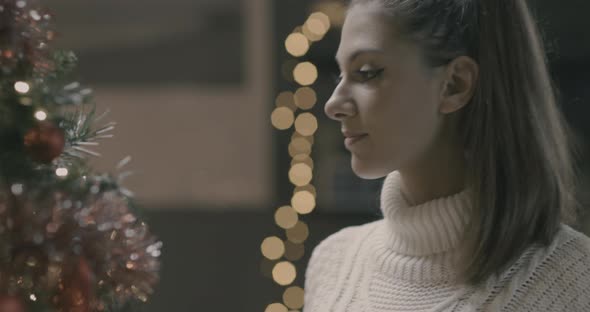 Young woman making christmas tree decoration.