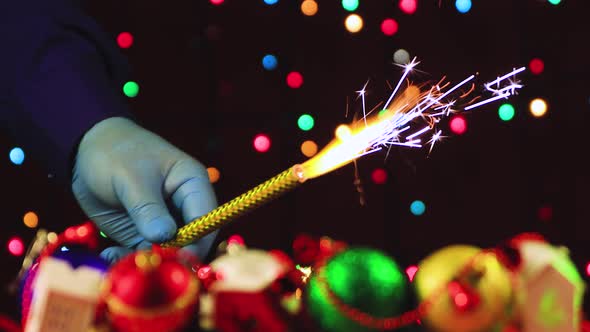 New Year's Video Screensaver Man's Hands in Gloves Light Fireworks