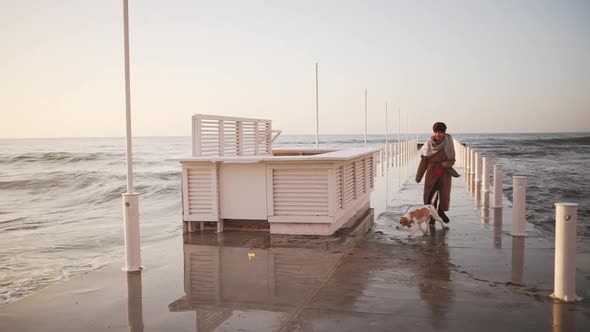 Slow Motion Outdoor Warmlydressed Woman Skipping with Nice Dog on Leash Near the Seaside