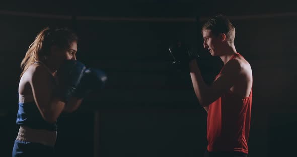 Young Adult Woman Doing Kickboxing Training with Her Coach.