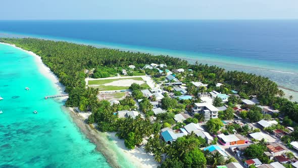 Wide angle drone travel shot of a paradise sunny white sand beach and turquoise sea background in be